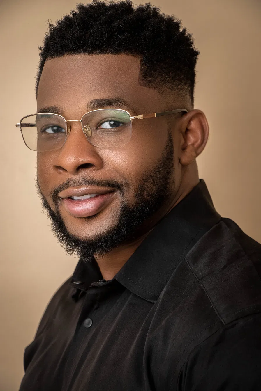 Francis Okafor, studio portrait on a dark ground